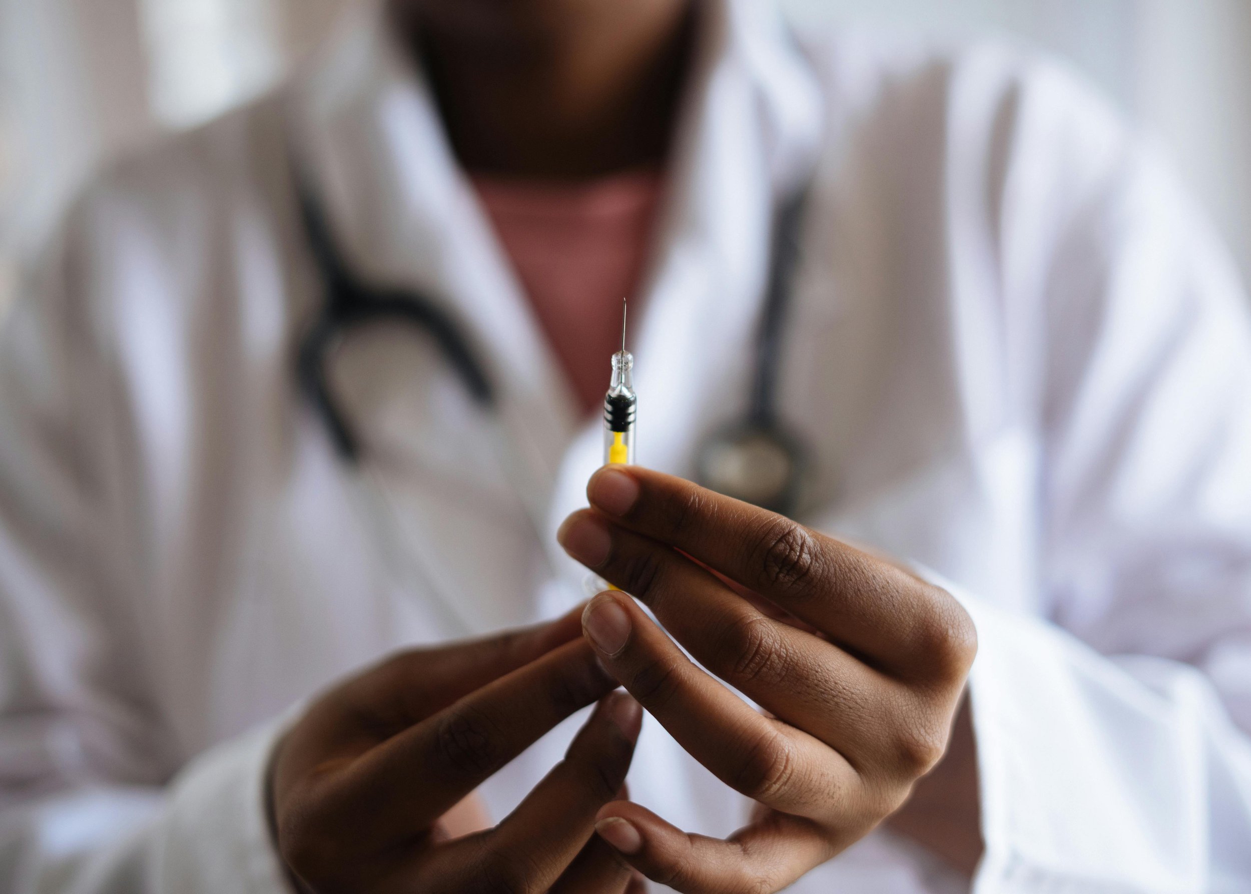 Doctor holding vaccination syringe
